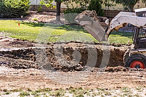 Small Bulldozer Digging In Yard For Pool Installation