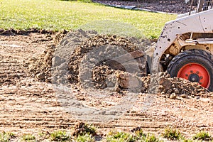 Small Bulldozer Digging In Yard For Pool Installation