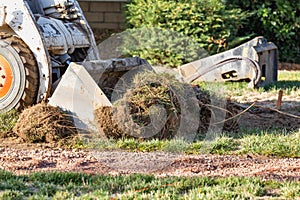 Small Bulldozer Removing Grass From Yard Preparing For Pool