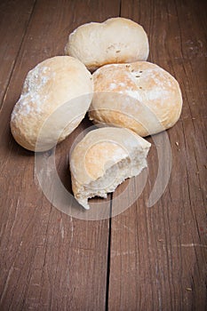 Small buns on a dark wooden background. Selective focus. Toned