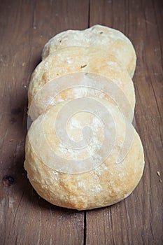 Small buns on a dark wooden background. Selective focus. Toned