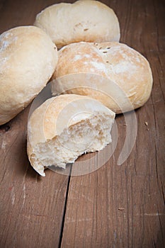 Small buns on a dark wooden background. Selective focus. Toned