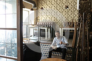 Small business closed due to COVID-19 or Coronavirus outbreak lockdown, businessman alone in his restaurant, cafe, bar