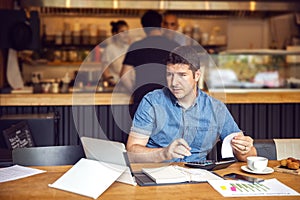 Small business owner calculating online restaurant financial bill taxes and expenses