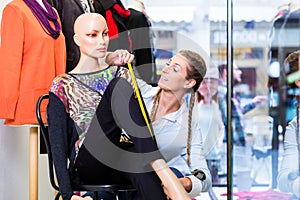 Small business owner dressing shop window