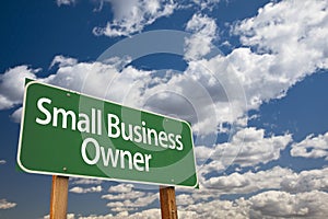 Small Business Owner Green Road Sign and Clouds