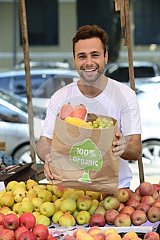 Small business owner selling organic fruits.