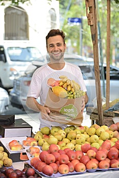 Small business owner selling organic fruits.