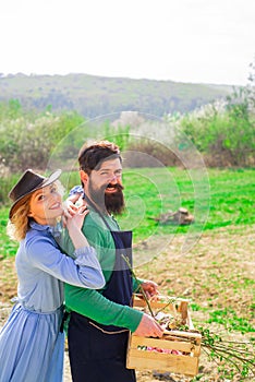 Small business owner selling organic fruits and vegetables. Image of two happy farmers with instruments. A farmer and