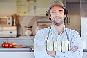 Small business owner smiling in front of his takeaway food busin