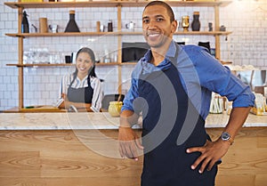 Small business owner or startup entrepreneur standing at a bar counter in a coffee shop or cafe as a team leader