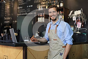 Small business owner working at his cafe