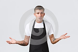 Small business owners, coffee shop and staff concept. Confused and worried barista cant understand what do, spread hands
