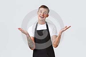 Small business owners, coffee shop and staff concept. Friendly-looking handsome guy looking delighted and happy