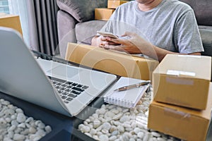 Small business parcel for shipment to client at home, Young entrepreneur SME freelance man working online business by using smart