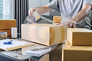 Small business parcel for shipment to client, Young entrepreneur SME freelance man working with packaging their packages box