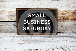 Small Business Saturday typography text on wooden blackboard