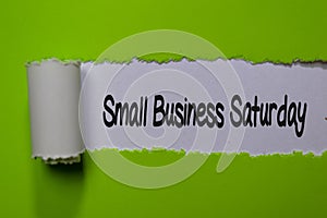 Small Business Saturday write on white and green torn paper photo