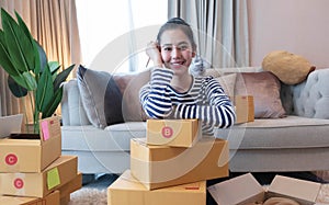 Small Business SME entrepreneur of Young Asian women working with laptop for Online shopping at home,Cheerful and Happy with box