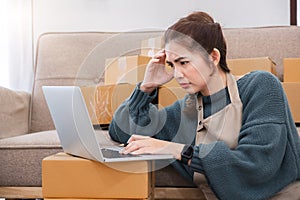 Small Business, Startup SME, Owner Entrepreneurs. Asian woman with unsuccess business online shopping crying and serious photo