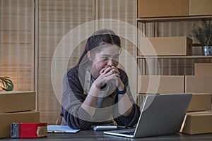 Small Business, Startup SME, Owner Entrepreneurs. Asian woman with unsuccess business online shopping crying and serious photo