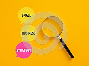 Small business strategy concept written on speech bubbles with magnifying glass