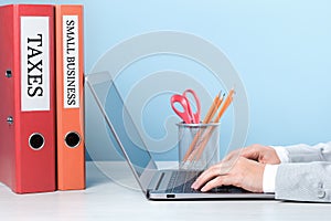 Small business and taxes binders on desk