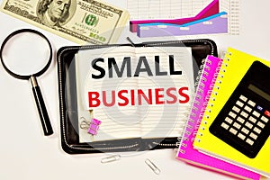 Small business. Text caption in the goal planning Notepad and a diagram of the company`s financial profit growth report.