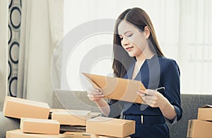 Small business woman preparing to send out her product in boxes