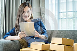 Small business woman preparing to send out her product in boxes