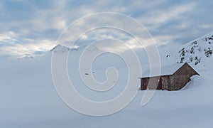 Small cabin and mountain in a gelid morning	Small cabin and mountain in a gelid morning photo