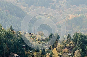 Small cabins in the mountains - autumn forest landscape