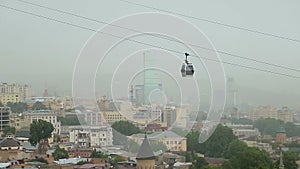 Small cable car running along cableroad transporting tourists and city residents