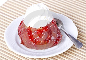 Small cake with cherry glaze and cream