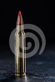 Small-caliber tracer cartridges on a dark photo