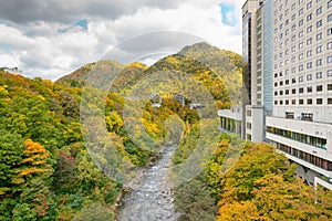 Small canal and mountain during autumn season at Jozankei onsen
