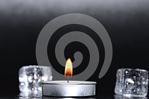 A small candle on a black background