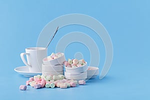 Small candy marshmallow in rosette on blue background