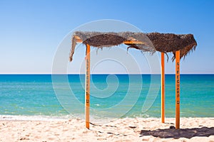 Small canopy at empty tropical beach on the