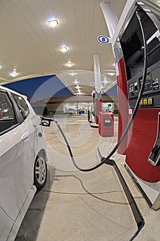 Small Car Refueling At Gasoline Station Convenience Store Revised