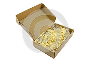 Small cardboard made of corrugated cardboard with an opening upper part filled with hay, isolated on a white background with a cli