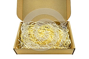 Small cardboard made of corrugated cardboard with an opening upper part filled with hay, isolated on a white background with a cli