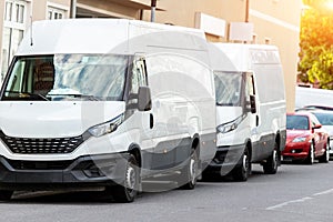 Small cargo delivery van parked in european city central district. Medium lorry minivan courier vehicle deliver package