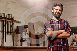 Small carpentry business owner smiling with arms crossed