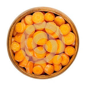 Small carrot slices, snack carrots cut into discs, in wooden bowl