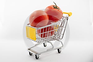 Small cart with tomatoes on a white background