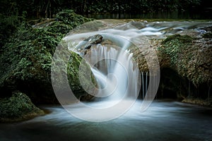 Small cascade flowing in the forest