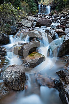 Small cascade under larger waterfall on creek in Colorado.