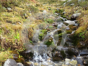 Small cascades with burbling water, alpine brook detail