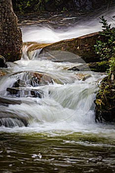 Small cascades flow at the bottom of Glen Cannon falls in North Carolina